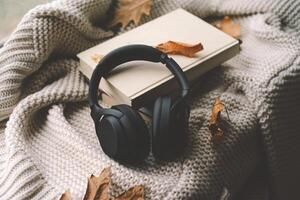 Cozy autumn setting with headphones on a book photo