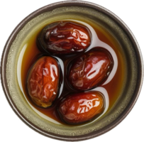 Sweet dates in syrup bowl top view. png