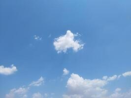 a large field with a few clouds in the sky photo