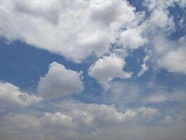 a view of the sky with clouds and a few trees photo