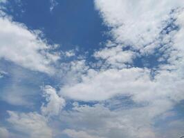 a view of the sky with clouds and a few airplanes photo