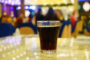 Close up of cold drink on the table with boken lights portrait background photo