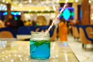 Close up refreshing classic mojito on the table with boken lights portrait background photo
