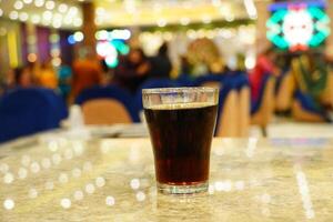 Close up of cold drink on the table with boken lights portrait background photo