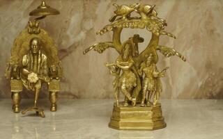 statue of Lord Radha Krishna selective focus and sai baba in background photo