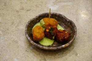 Pakore Is Made Of Moong Dal, Yellow Mung Lentils, Chana Daal with red and green sauce photo