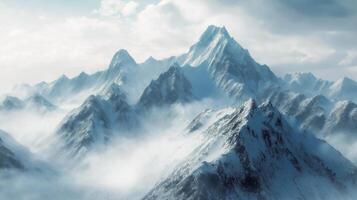 A mountain range is covered in snow and fog photo