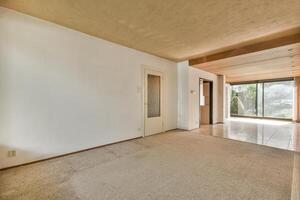 A room with a carpeted floor and a door photo