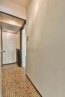 A hallway with tile floors and a door photo