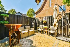 A patio with a fire pit and chairs photo
