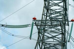 High voltage towers with sky background. Power line support with wires for electricity transmission. High voltage grid tower with wire cable at distribution station. Energy industry, energy saving photo
