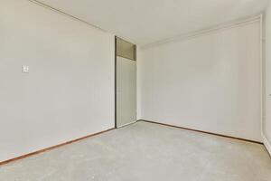 An empty room with a door and a window photo