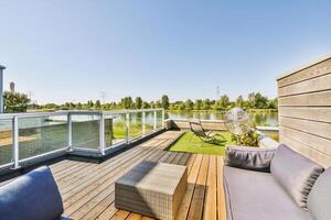 A wooden deck with a patio and a view of the water photo