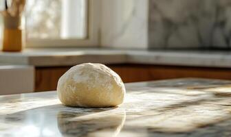 Freshly kneaded dough on a granite counter photo