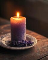 A tall lavender-scented candle flickering softly, resting on a ceramic plate on a wooden table photo