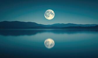 Bright full moon reflected in a still lake, distant hills barely visible in the darkness photo