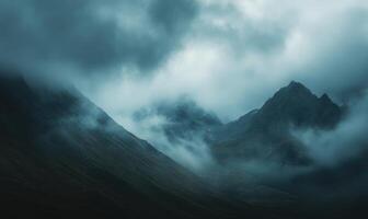 Dark clouds looming over a jagged mountain range photo
