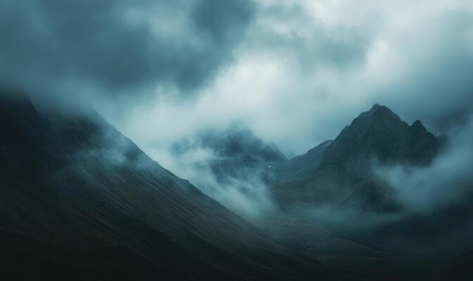 Dark clouds looming over a jagged mountain range