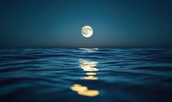 Bright full moon reflected in a calm sea photo