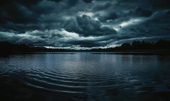Dark and brooding clouds gathering over a quiet lake photo