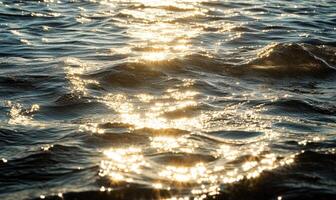 Close-up of small waves in a lake, sunlight sparkling on the water photo
