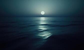 Moonlight casting a soft glow on a calm sea photo