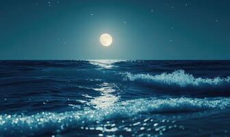 Ocean waves gently rolling in, bright moonlight casting a shimmering path on the water photo