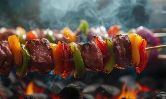 Skewers of colorful peppers and onions grilling over hot coals photo