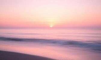 A beautiful beach with a pink and orange sunset in the background photo