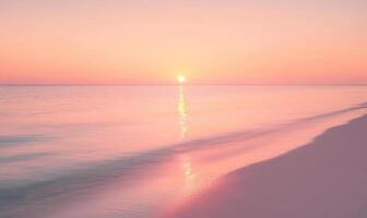 A beautiful beach with a pink and orange sunset in the background photo