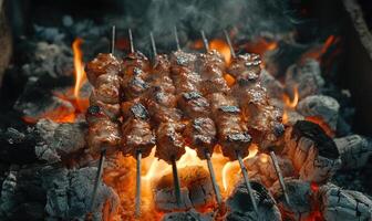 Skewers of mixed meat and vegetables on a grill photo