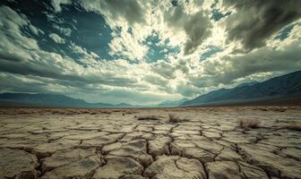 Thick clouds rolling across the sky, casting shadows over a rocky desert landscape photo