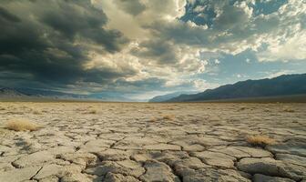 Thick clouds rolling across the sky, casting shadows over a rocky desert landscape photo
