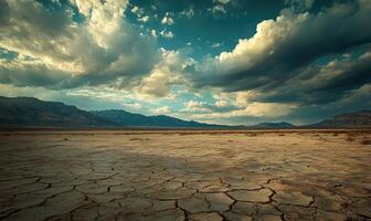 Thick clouds rolling across the sky, casting shadows over a rocky desert landscape photo