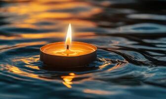 Single floating candle on rippling water, soft golden glow illuminating the scene photo