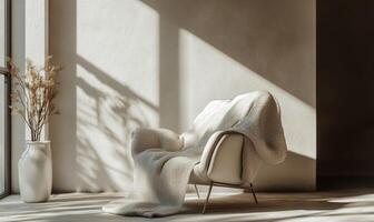 A white chair with a blanket draped over it is sitting in a room with a window photo