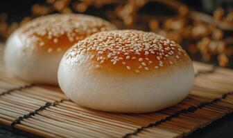 Two small round pastries with sesame seeds on top photo