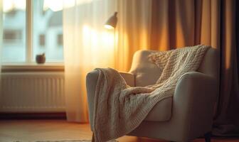 A chair with a white blanket draped over it sits in front of a window photo