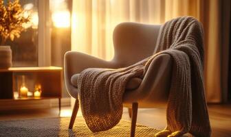 A chair is covered in a blanket and is sitting in front of a window photo