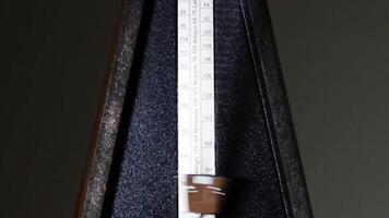 Tight Shot Of Mechanical Metronome Arm Moving At Fast Speed Dark Background video