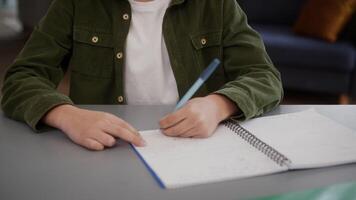 Concentrated African American son kid child boy pupil student schoolboy at home studying writing task lesson class course learning study learn thinking pondering dreaming think decision search answer video