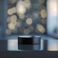 A black object sitting on a table in front of a window photo