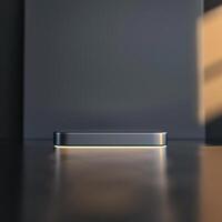 A silver box sitting on a table in front of a wall photo