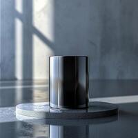 A black vase sitting on a table in front of a window photo