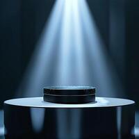 A spotlight shines on a black object on a table photo