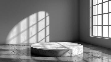 A black and white photo of a marble round table in a room