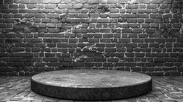 Black and white photo of a round table in front of a brick wall