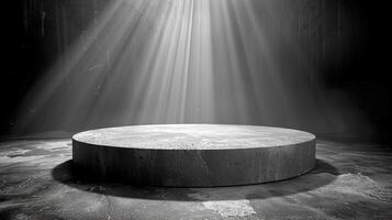 A black and white photo of a round table in the middle of a room