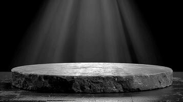 Black and white photo of a stone pedestal with light shining from above