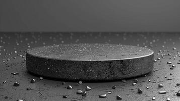 A black round table with a few pebbles on it photo